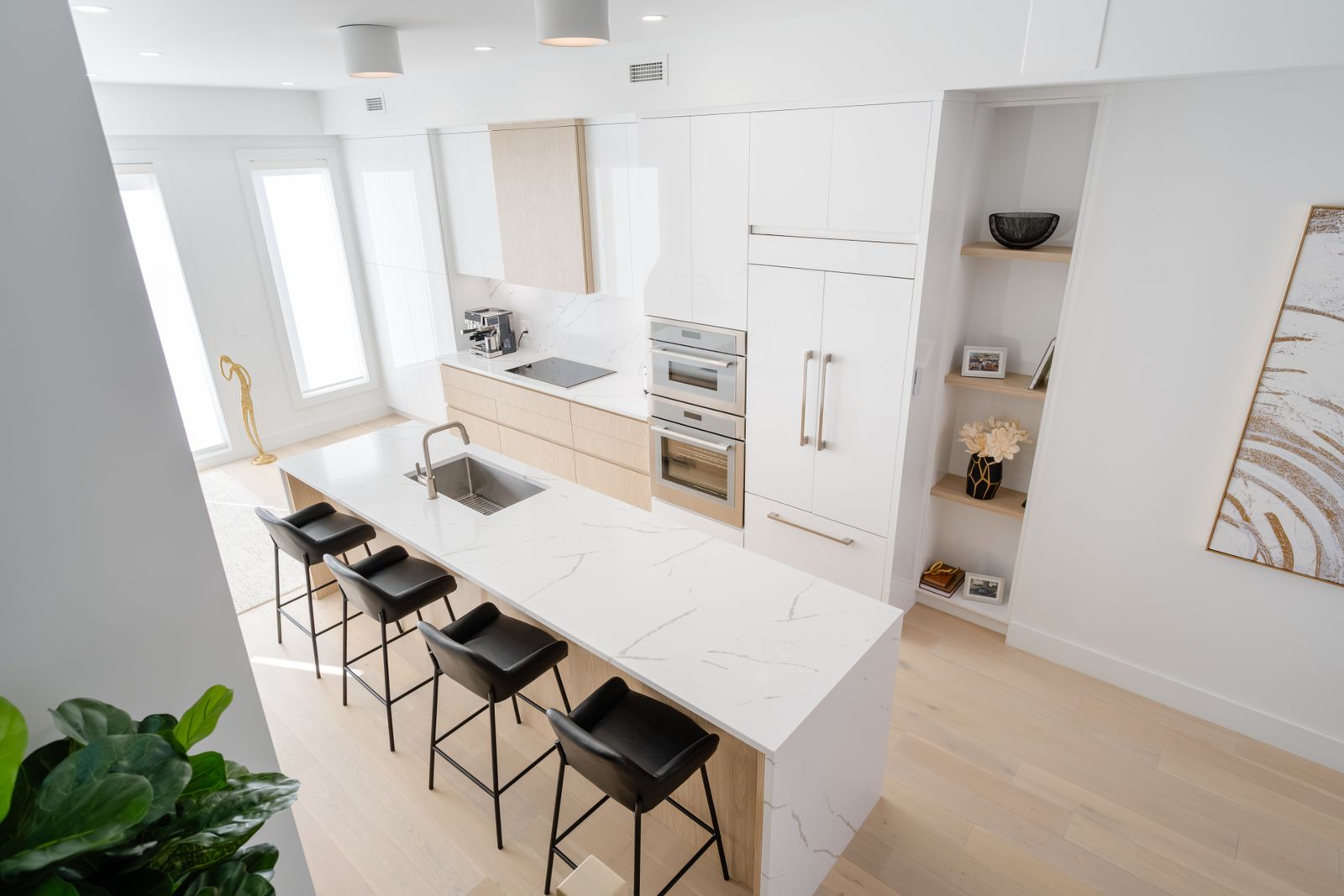 Bright modern kitchen with a large stone island and integrated sink